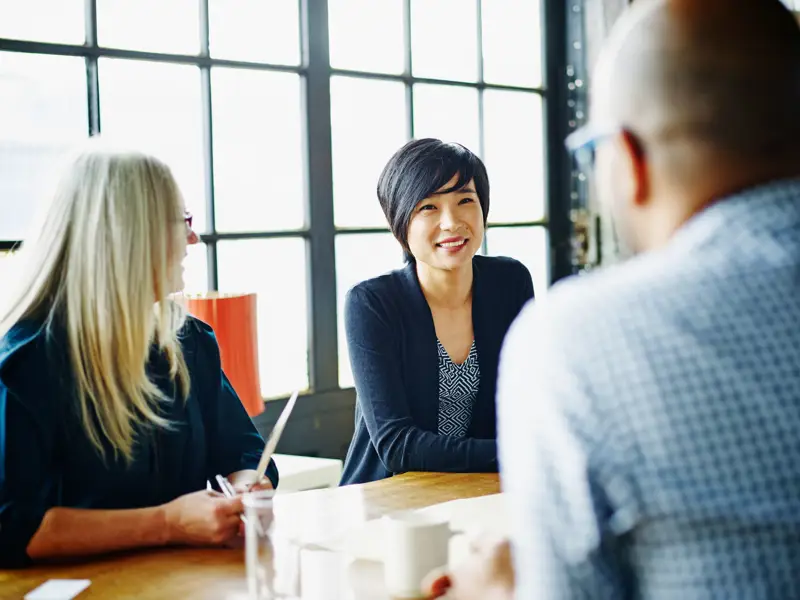 Businesswoman leading discussion with colleagues.